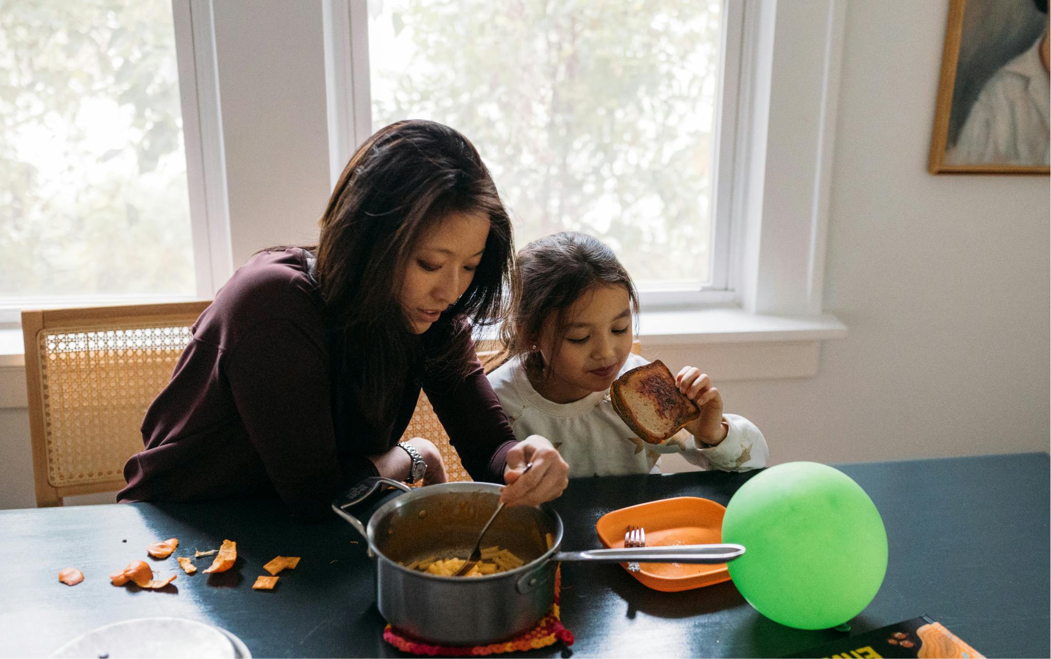 A mother eating with her daughter